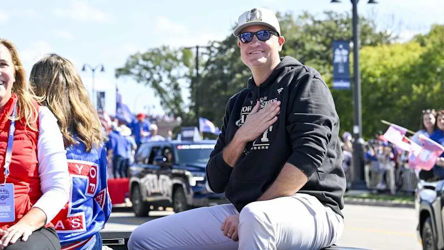 Texas Rangers general manager Chris Young smiles to fans during a parade