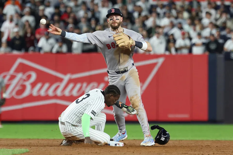 Oct 2, 2025; Bronx, New York, USA; Boston Red Sox shortstop Trevor Story (10) commits a throwing error after forcing out New York Yankees second baseman Jazz Chisholm Jr. (13) out at second base in the sixth inning during game three of the Wildcard round for the 2025 MLB playoffs at Yankee Stadium. (Vincent Carchietta/Imagn Images)