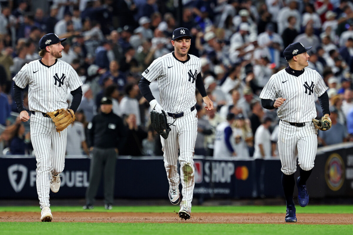 Oct 8, 2025; Bronx, New York, USA; New York Yankees left fielder Cody Bellinger (35) runs off the field after ending the first inning with a sliding catch against the Toronto Blue Jays during game four of the ALDS round for the 2025 MLB playoffs at Yankee Stadium. Mandatory Credit: Vincent Carchietta-Imagn Images