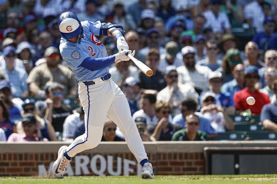 Jul 18, 2025; Chicago, Illinois, USA; Chicago Cubs second baseman Nico Hoerner (2) hits an RBI-single against the Boston Red Sox during the sixth inning at Wrigley Field. (Kamil Krzaczynski/Imagn Images)