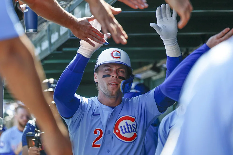 Sep 26, 2025; Chicago, Illinois, USA; Chicago Cubs second baseman Nico Hoerner (2) celebrates with teammates in the dugout after hitting a solo home run against the St. Louis Cardinals during the first inning at Wrigley Field. (Kamil Krzaczynski/Imagn Images)
