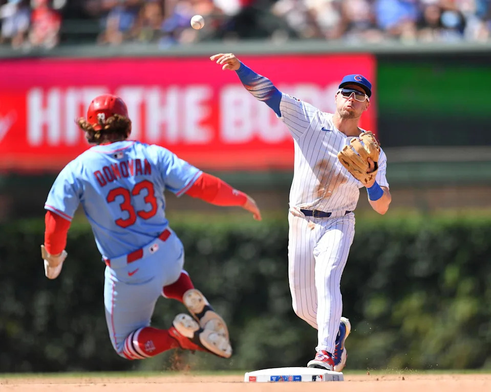 Jul 5, 2025; Chicago, Illinois, USA; Chicago Cubs second baseman Nico Hoerner (2) completes a double play after forcing out St. Louis Cardinals second baseman Brendan Donovan (33) during the seventh inning at Wrigley Field. (Patrick Gorski/Imagn Images)