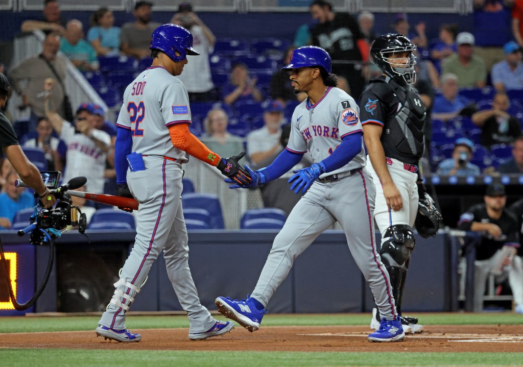 Francisco Lindor #12 of the New York Mets is greeted by Juan Soto #22 of the New York Mets after he scores on his solo home run.