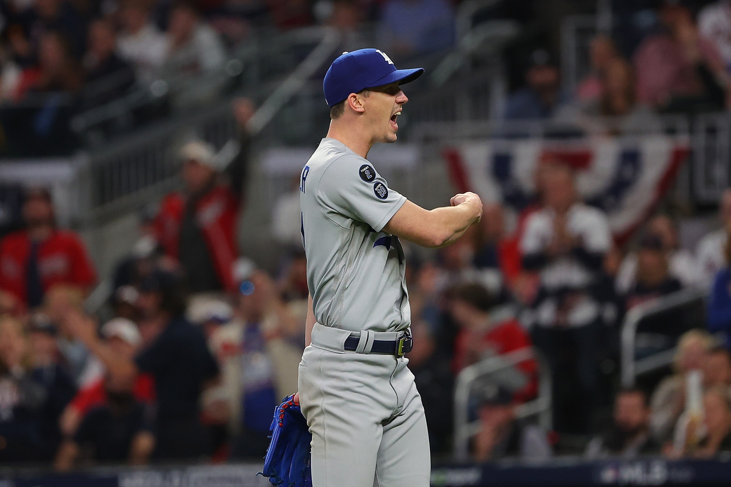 ATLANTA, GEORGIA - OCTOBER 23: Walker Buehler #21 of the Los Angeles Dodgers reacts to a play during the fourth inning of Game Six of the National League Championship Series against the Atlanta Braves at Truist Park on October 23, 2021 in Atlanta, Georgia. (Photo by Kevin C. Cox/Getty Images)