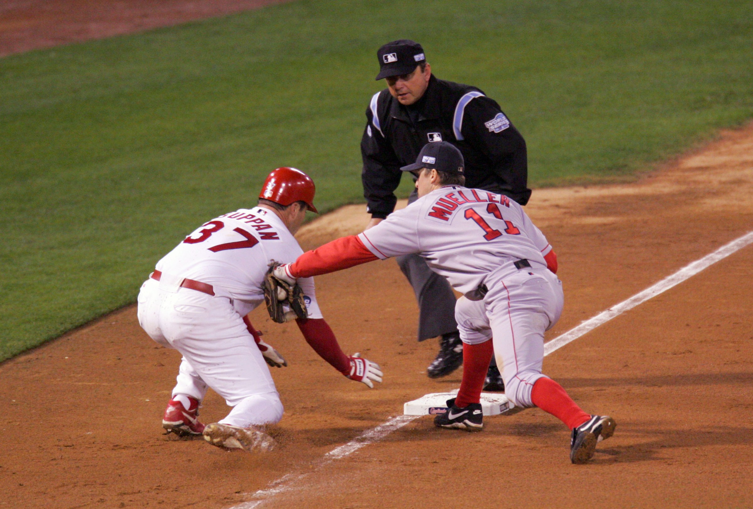 ST. LOUIS - OCTOBER 26: Bill Mueller #11 of the Boston Red Sox tags out Jeff Suppan #37 of the St. Louis Cardinals at third base during game three of the 2004 World Series against the St. Louis Cardinals at Busch Stadium on October 26, 2004 in St. Louis, Missouri.(Photo by Brad Mangin/MLB Photos via Getty Images)