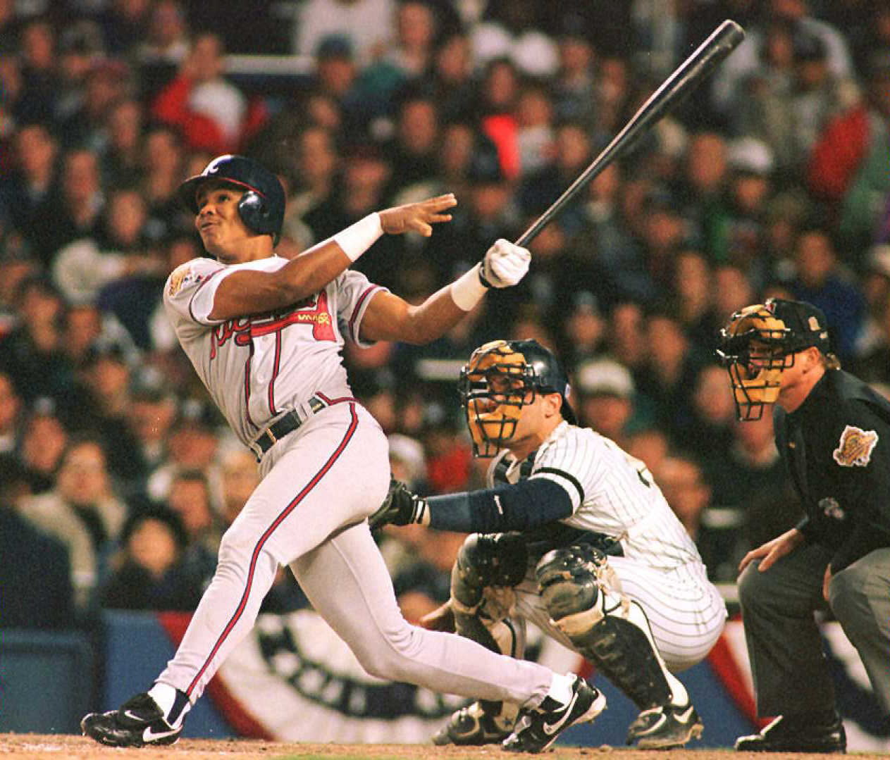 NEW YORK, NY - OCTOBER 20: Atlanta Braves player Andruw Jones (L) watches his second home run fly out of the park in the third inning of Game One of the World Series against the New York Yankees at Yankee Stadium in New York 20 October. Jones, the youngest player to hit a home run in the World Series, had two home runs in his first two at bats. (Photo credit should read TIMOTHY CLARY/AFP via Getty Images)