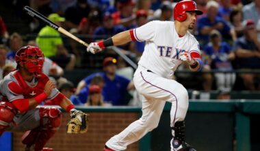 FILE - Texas Rangers' Carlos Beltran follows through on a two-run home run swing as Los Angeles Angels catcher Carlos Perez watches in the fifth inning of a baseball game, Sept. 21, 2016, in Arlington, Texas. (AP Photo/Tony Gutierrez, File)