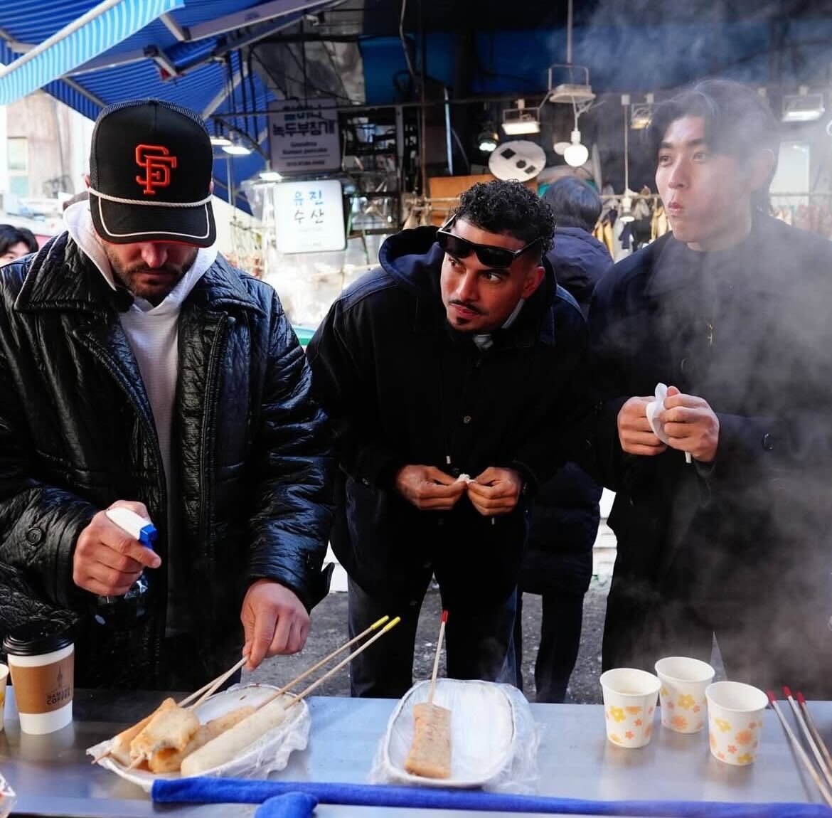 From left: Tony Vitello, Willy Adames and Lee Jung-hoo eat street food at Namdaemun Market on Tuesday. (San Francisco Giants)