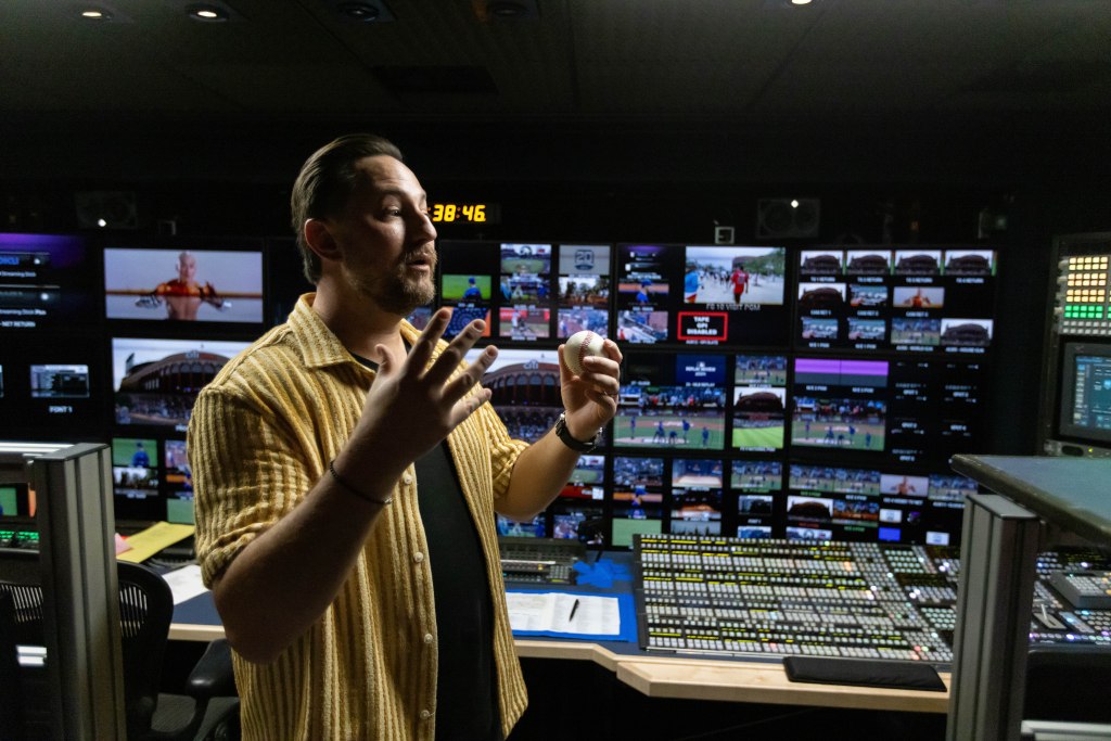 Director John Marisco holding a baseball in the SportsNet New York (SNY) production truck.