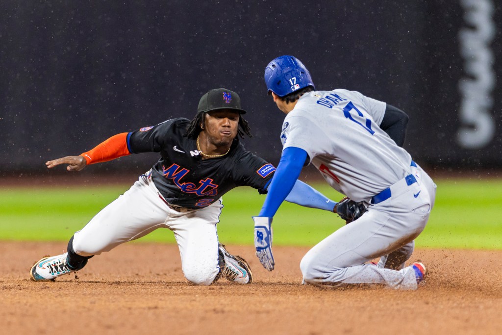 New York Mets second baseman Luisangel Acuña tags out Los Angeles Dodgers two-way player Shohei Ohtani at second base.