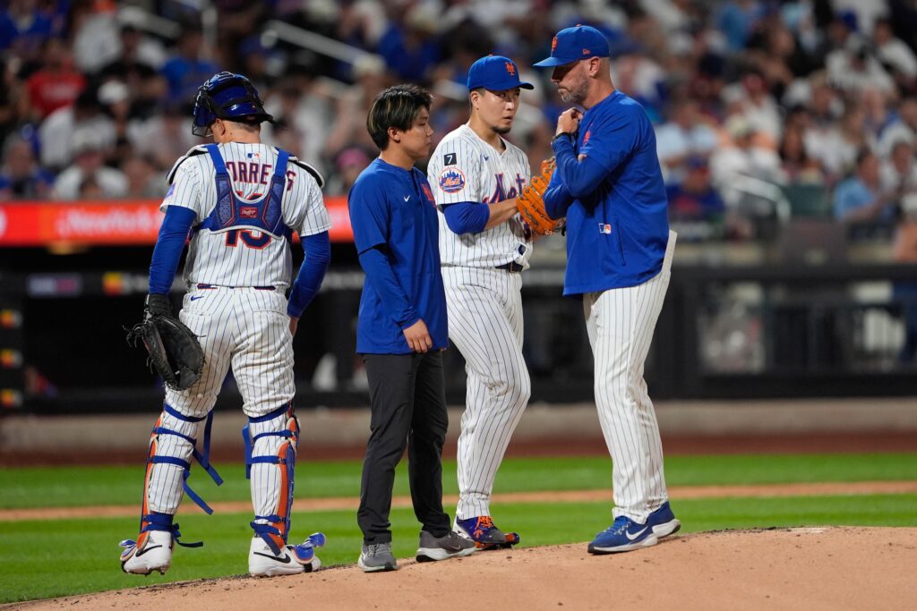 New York Mets pitching coach Jeremy Hefner (65) speaks with New York Mets pitcher Kodai Senga (34) during the third inning against the Philadelphia Phillies at Citi Field on Aug. 25.