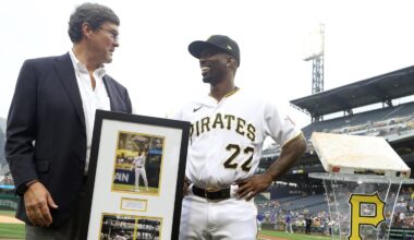 Jun 20, 2023; Pittsburgh, Pennsylvania, USA; Pittsburgh Pirates chairman Robert Nutting (left) presents designated hitter Andrew McCutchen (22) with a plaque and a base in commemoration of McCutchen's 2000th career MLB hit before the game against the Chicago Cubs at PNC Park. Mandatory Credit: Charles LeClaire-Imagn Images