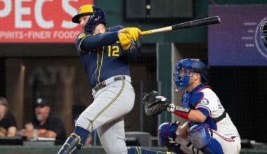 Sep 10, 2025; Arlington, Texas, USA; Milwaukee Brewers first baseman Rhys Hoskins (12) follows through on his RBI single against the Texas Rangers during the sixth inning at Globe Life Field. Mandatory Credit: Jim Cowsert-Imagn Images