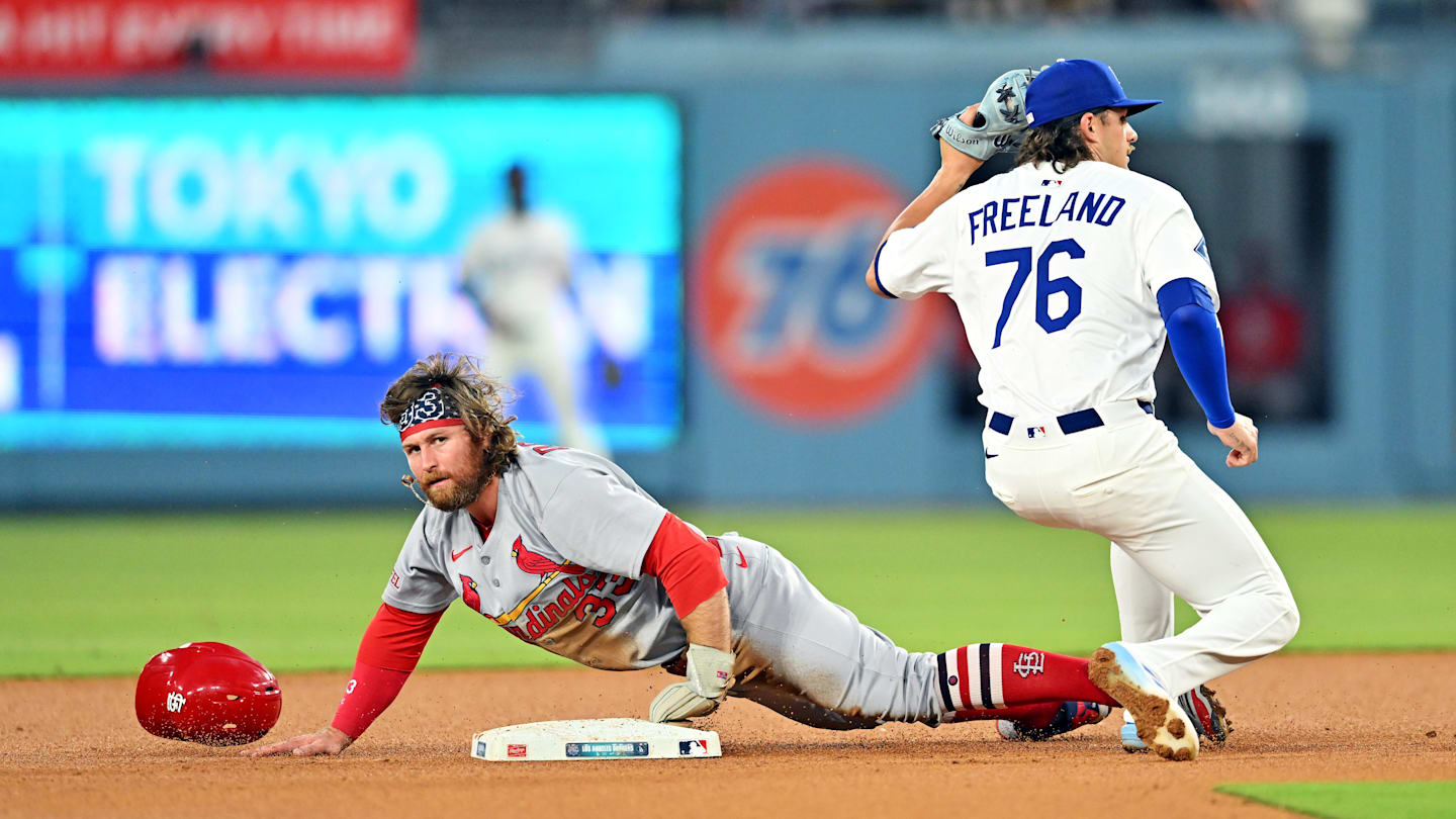 Aug 5, 2025: Los Angeles Dodgers shortstop Alex Freeland (76) tags out St. Louis Cardinals second base Brendan Donovan (33) at second base during the third inning at Dodger Stadium.