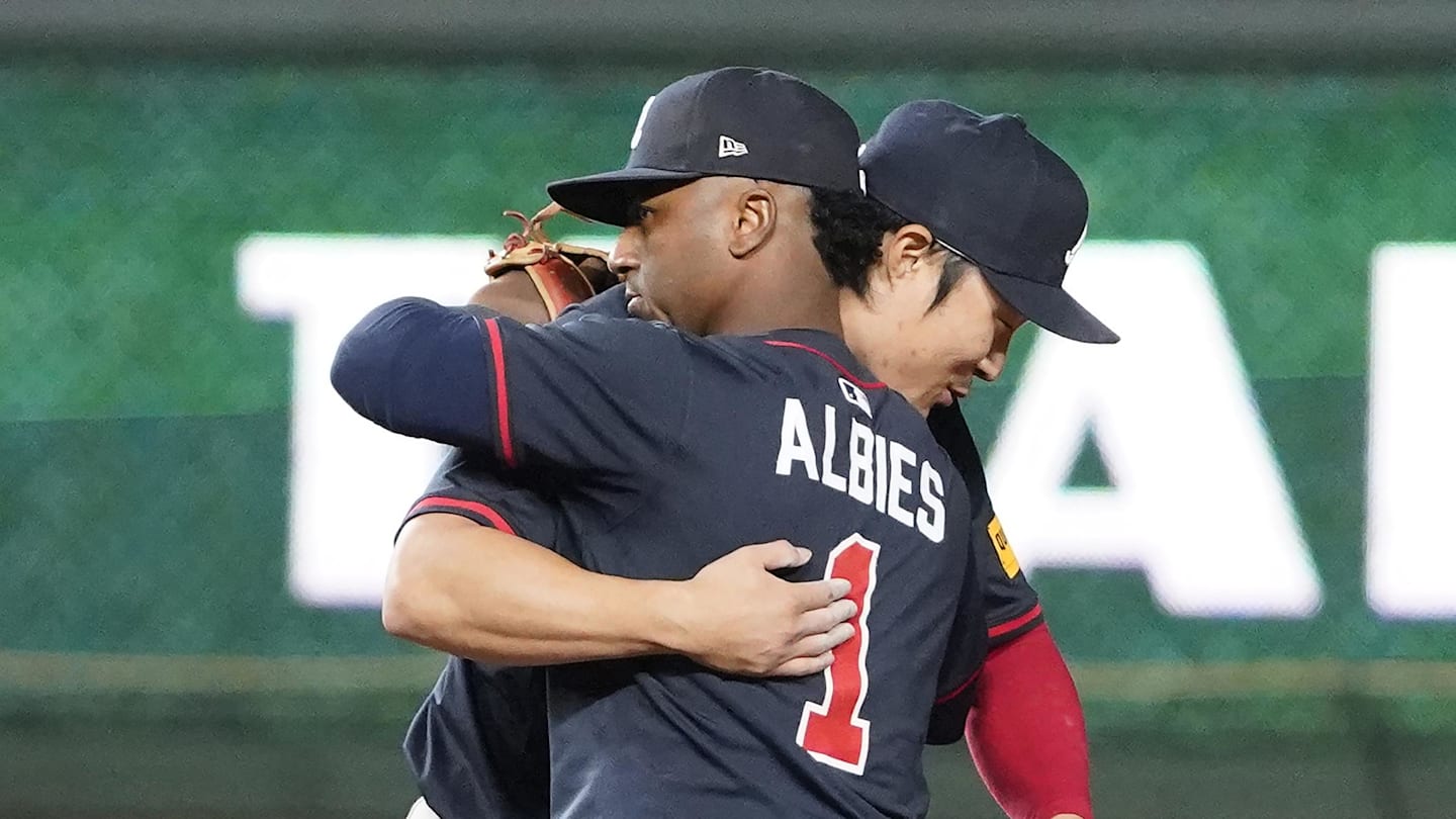 Sep 3, 2025; Chicago, Illinois, USA; Atlanta Braves shortstop Ha-Seong Kim (9) and second baseman Ozzie Albies (1) celebrate their win against the Chicago Cubs at Wrigley Field. Mandatory Credit: David Banks-Imagn Images