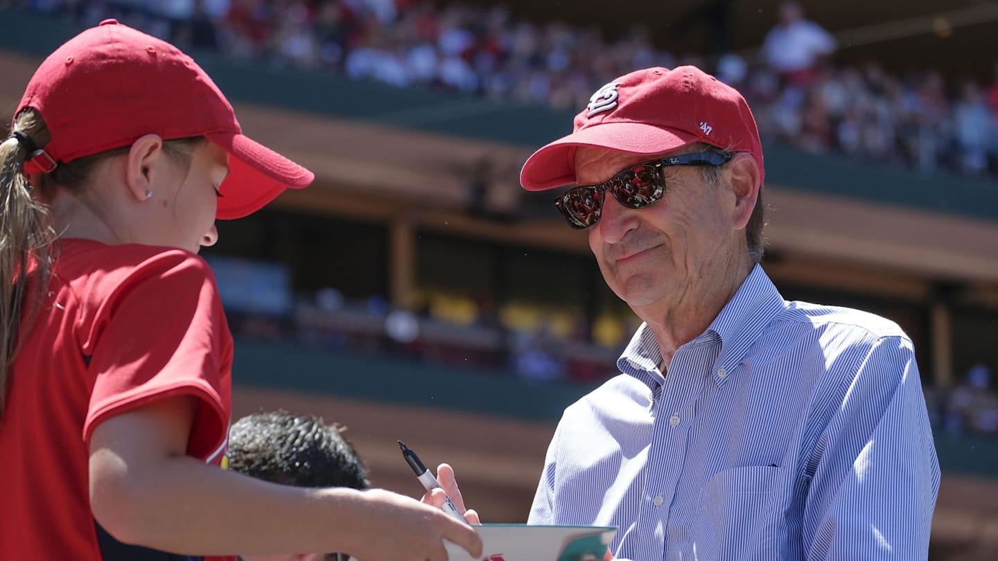 Jun 3, 2018; St. Louis, MO, USA; St. Louis Cardinals principal owner and chairman Bill DeWitt Jr. signs an autograph for a young fan during the seventh inning against the Pittsburgh Pirates at Busch Stadium. Mandatory Credit: Scott Rovak-Imagn Images