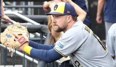 Jul 2, 2025; New York City, New York, USA;  Milwaukee Brewers first baseman Rhys Hoskins (12) watches from the dugout prior to game against the New York Mets at Citi Field.