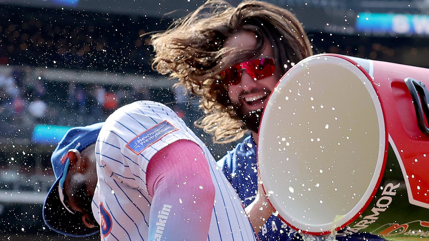 Apr 23, 2025; New York City, New York, USA; New York Mets designated hitter Jesse Winker (3) douses teammate Starling Marte (6) after Marte hit a walkoff single against the Philadelphia Phillies in the tenth inning at Citi Field. Mandatory Credit: Brad Penner-Imagn Images