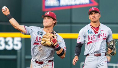 Jun 18, 2025; Omaha, Neb, USA; Arkansas Razorbacks second baseman Cam Kozeal (8) throws to first during the second inning against the LSU Tigers at Charles Schwab Field. Mandatory Credit: Dylan Widger-Imagn Images