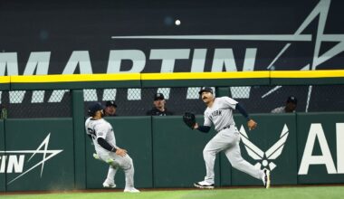 Aug 5, 2025; Arlington, Texas, USA;  New York Yankees center fielder Trent Grisham (12) makes a catch in front of New York Yankees left fielder Jasson Dominguez (24) during the seventh inning against the Texas Rangers at Globe Life Field. Mandatory Credit: Kevin Jairaj-Imagn Images