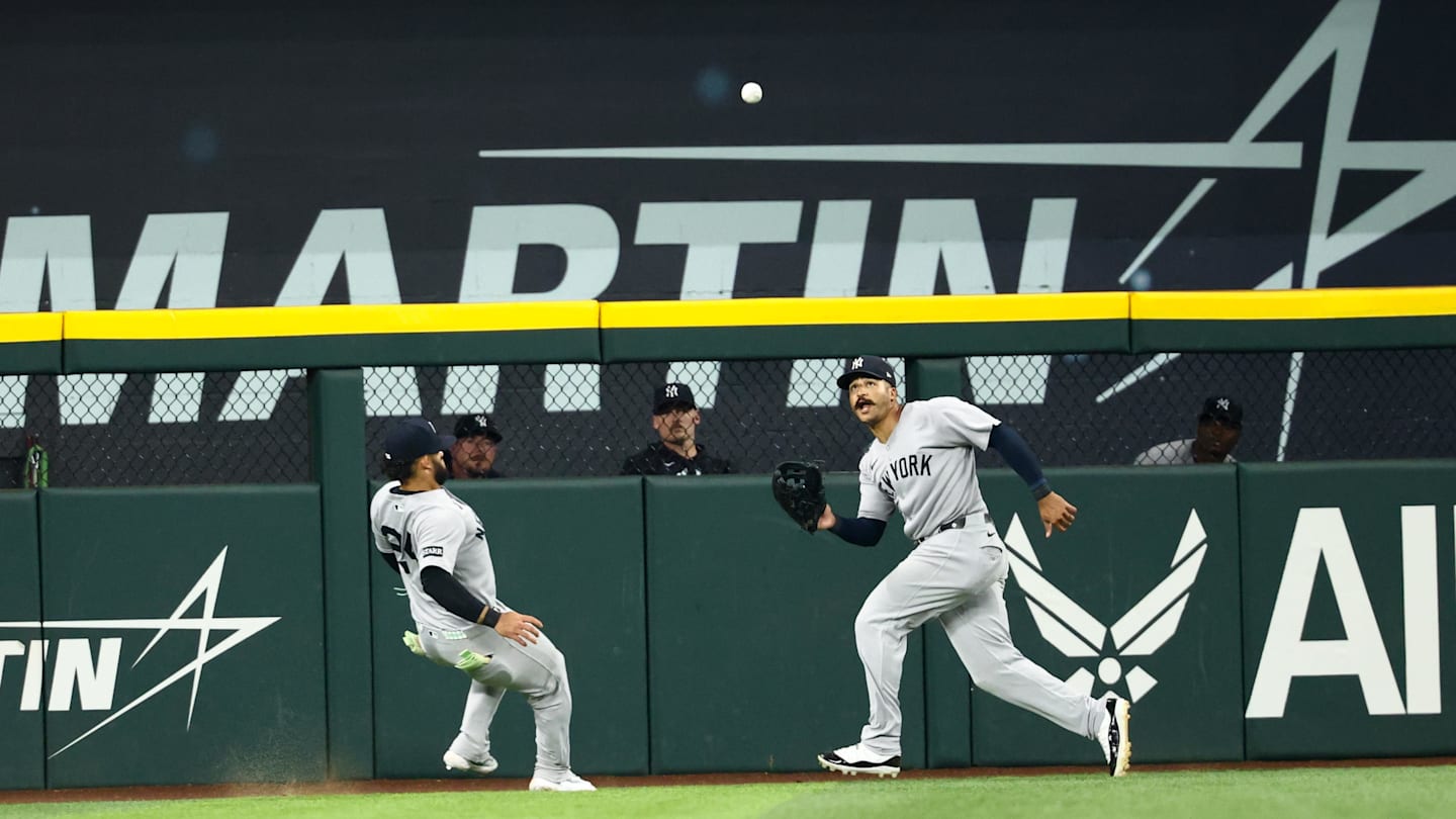 Aug 5, 2025; Arlington, Texas, USA;  New York Yankees center fielder Trent Grisham (12) makes a catch in front of New York Yankees left fielder Jasson Dominguez (24) during the seventh inning against the Texas Rangers at Globe Life Field. Mandatory Credit: Kevin Jairaj-Imagn Images