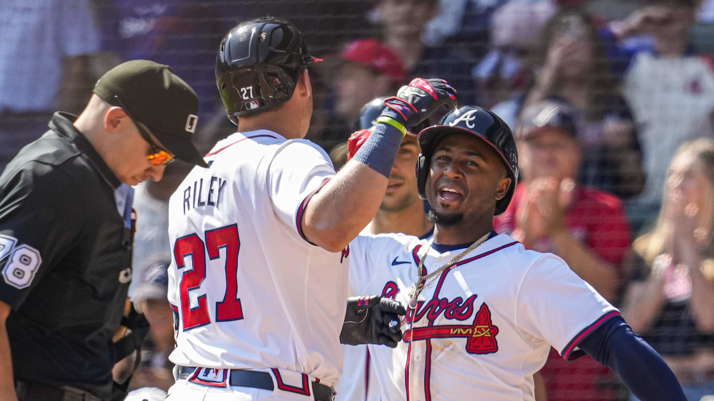 Apr 7, 2024; Cumberland, Georgia, USA; Atlanta Braves third baseman Austin Riley (27) reacts with second baseman Ozzie Albies (1) after hitting a home run against the Arizona Diamondbacks during the eighth inning at Truist Park. Mandatory Credit: Dale Zanine-Imagn Images
