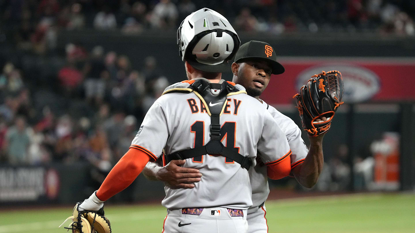 Sep 17, 2025; Phoenix, Arizona, USA; San Francisco Giants catcher Patrick Bailey (14) and pitcher Joel Peguero (63) celebrate after defeating the Arizona Diamondbacks at Chase Field. Mandatory Credit: Rick Scuteri-Imagn Images