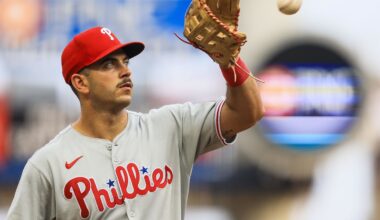 Aug 11, 2025; Cincinnati, Ohio, USA; Philadelphia Phillies third baseman Otto Kemp (4) catches a ball as he walks off the field at the end of the third inning in the game against the Cincinnati Reds at Great American Ball Park.