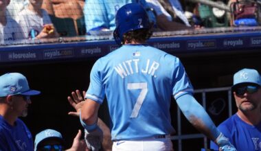 Mar 11, 2024; Surprise, Arizona, USA; Kansas City Royals shortstop Bobby Witt Jr. (7) returns to the dugout after scoring a run against the San Francisco Giants during the first inning at Surprise Stadium. Mandatory Credit: Joe Camporeale-Imagn Images
