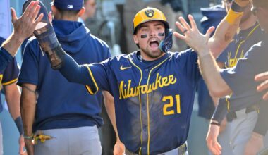 Oct 16, 2025; Los Angeles, California, USA; Milwaukee Brewers third baseman Caleb Durbin (21) celebrates in the dugout after scoring against the Los Angeles Dodgers in the second inning during game three of the NLCS round for the 2025 MLB playoffs at Dodger Stadium. Mandatory Credit: Jayne Kamin-Oncea-Imagn Images