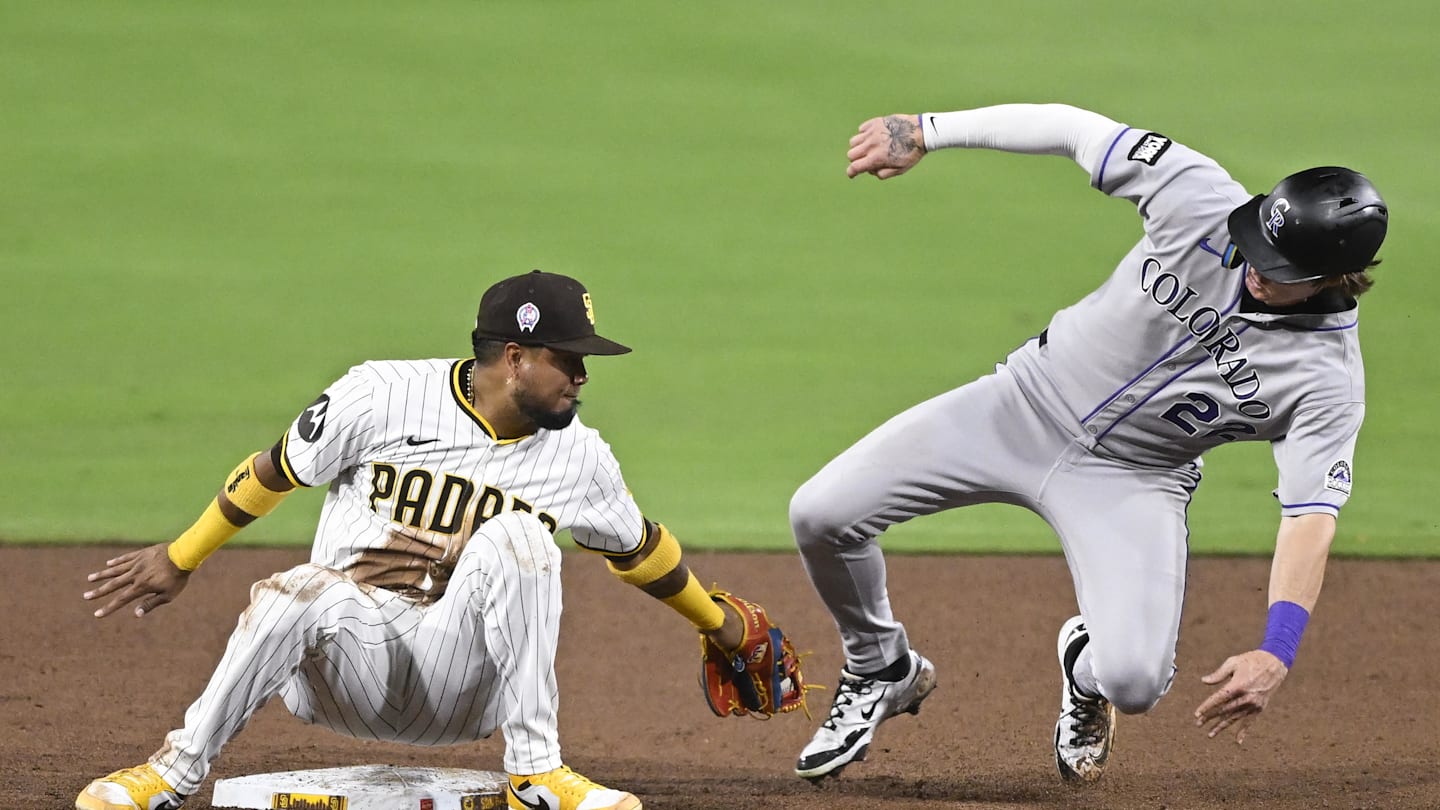 Sep 11, 2025; San Diego, California, USA; Colorado Rockies right fielder Mickey Moniak (22) steals second as San Diego Padres second baseman Luis Arraez (4) tries to make the tag during the sixth inning at Petco Park. Mandatory Credit: Denis Poroy-Imagn Images
