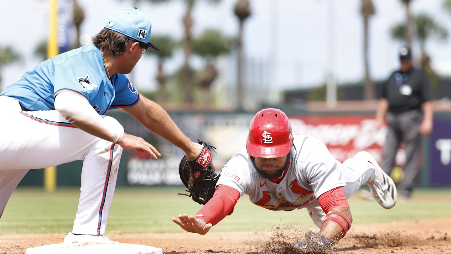 Mar 16, 2025; Jupiter, Florida, USA;  St. Louis Cardinals center fielder Victor Scott II (11) is picked off by Miami Marlins first baseman Jonah Bride (41) during the third inning  at Roger Dean Chevrolet Stadium. Mandatory Credit: Rhona Wise-Imagn Images