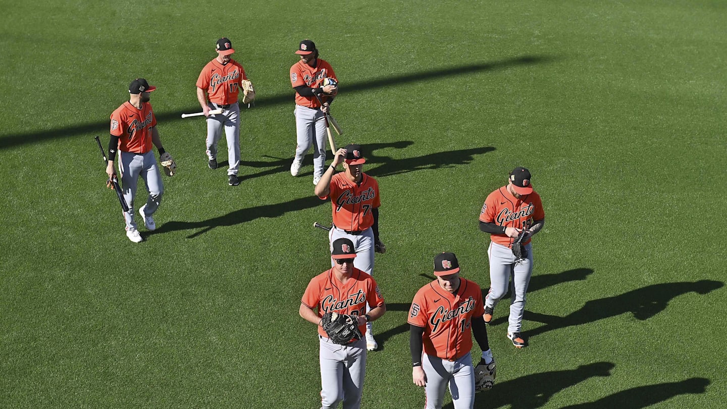 Feb 10, 2026; Scottsdale, AZ, USA;  Members of the San Francisco Giants walk across the field during a Spring Training workout at Scottsdale Stadium Mandatory Credit: Matt Kartozian-Imagn Images