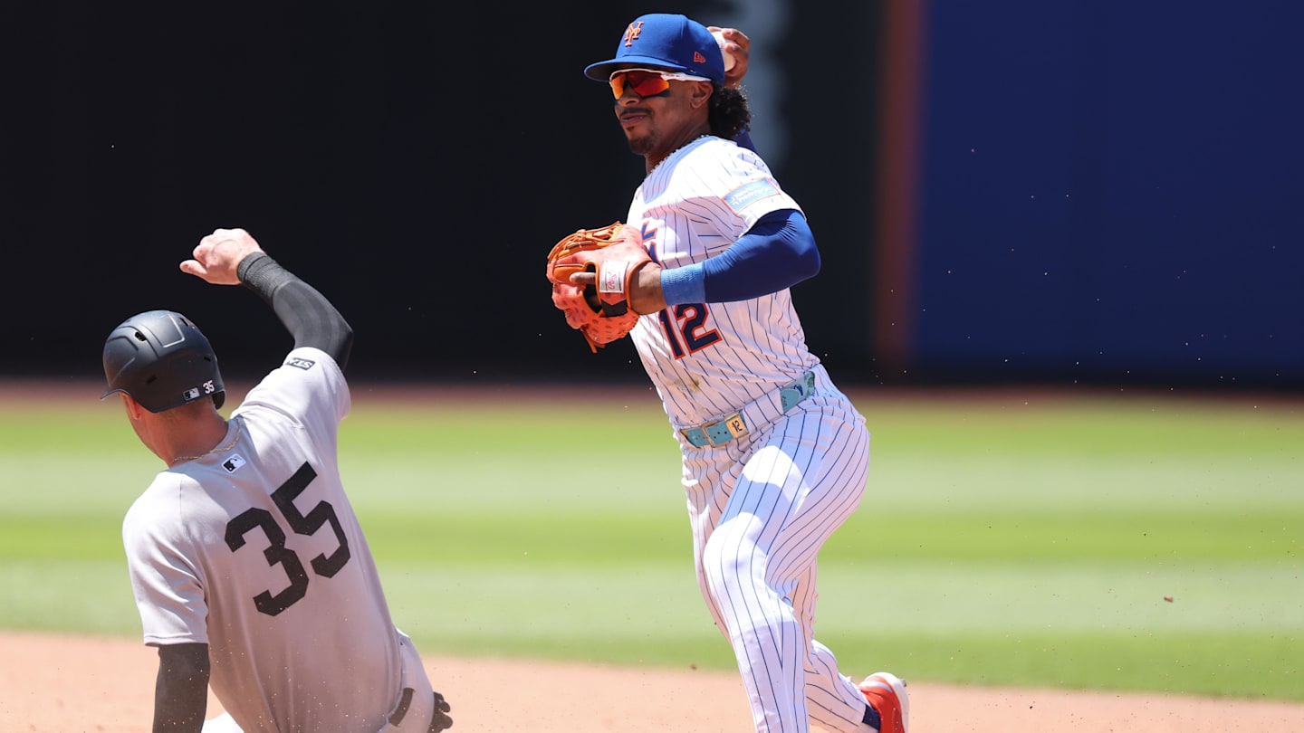 New York Mets shortstop Francisco Lindor attempts to turn a double play after forcing out Yankees left fielder Cody Bellinger.