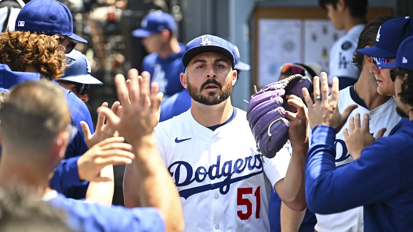 Jul 20, 2025; Los Angeles, California, USA; Los Angeles Dodgers pitcher Alex Vesia (51) celebrates with teammates in the dugout after pitching a strikeout to end the fifth inning against the Milwaukee Brewers at Dodger Stadium. Mandatory Credit: Jonathan Hui-Imagn Images