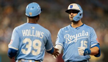 Sep 20, 2025; Kansas City, Missouri, USA; Kansas City Royals outfielder Randal Grichuk (15) slaps hands with Kansas City Royals first base coach Damon Hollins (39) after getting on first base during the seventh inning against the Toronto Blue Jays at Kauffman Stadium. Mandatory Credit: William Purnell-Imagn Images