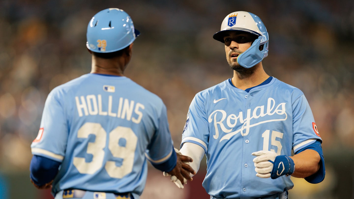 Sep 20, 2025; Kansas City, Missouri, USA; Kansas City Royals outfielder Randal Grichuk (15) slaps hands with Kansas City Royals first base coach Damon Hollins (39) after getting on first base during the seventh inning against the Toronto Blue Jays at Kauffman Stadium. Mandatory Credit: William Purnell-Imagn Images