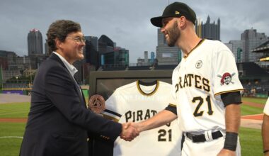Sep 15, 2021; Pittsburgh, Pennsylvania, USA;  Pittsburgh Pirates chairman Robert Nutting (left) presents catcher Jacob Stallings (58) the team Roberto Clemente award before the game against the Cincinnati Reds at PNC Park. Major League Baseball has designated today as Roberto Clemente Day.across the league. Mandatory Credit: Charles LeClaire-Imagn Images