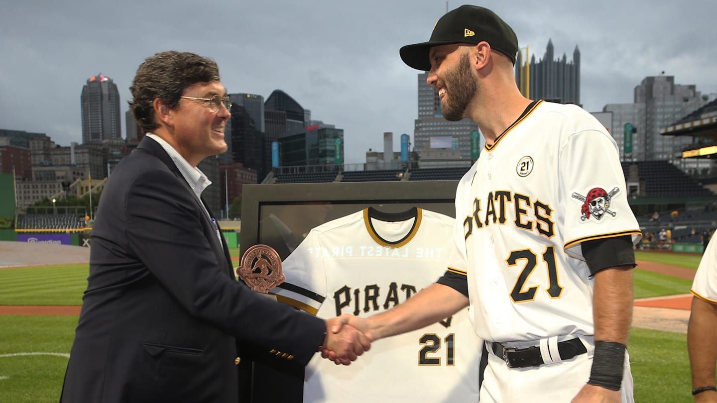 Sep 15, 2021; Pittsburgh, Pennsylvania, USA;  Pittsburgh Pirates chairman Robert Nutting (left) presents catcher Jacob Stallings (58) the team Roberto Clemente award before the game against the Cincinnati Reds at PNC Park. Major League Baseball has designated today as Roberto Clemente Day.across the league. Mandatory Credit: Charles LeClaire-Imagn Images