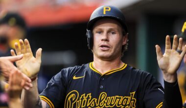 Jack Suwinski (65) high fives teammates after scoring on a RBI single.