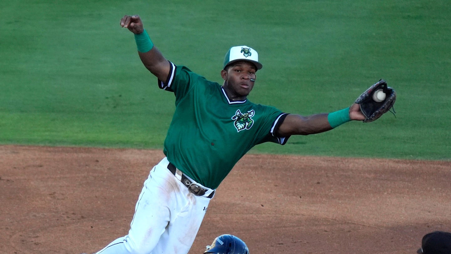June 18, 2025; North Augusta, South Carolina, USA; Augusta GreenJacket infielder John Gil (7) jumps for the ball as Lynchburg Tommy Hawke (2) slides into second during the second game of the Auugsta GreenJackets and Lynchburg Hillcats baseball game at SRP Park. Mandatory Credit: Katie Goodale - Augusta Chronicle/USA TODAY NETWORK