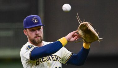 Jun 9, 2025; Milwaukee, Wisconsin, USA;  Milwaukee Brewers first baseman Rhys Hoskins (12) warms up before game against the Atlanta Braves at American Family Field. Mandatory Credit: Benny Sieu-Imagn Images