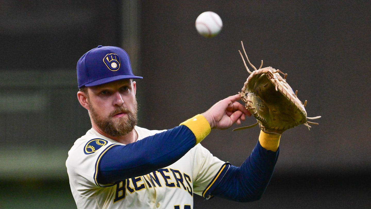 Jun 9, 2025; Milwaukee, Wisconsin, USA;  Milwaukee Brewers first baseman Rhys Hoskins (12) warms up before game against the Atlanta Braves at American Family Field. Mandatory Credit: Benny Sieu-Imagn Images