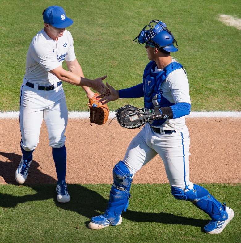 Kellan Montgomery, left, a former Dos Pueblos High School star, changed uniforms this fall after transferring to UCSB from Long Beach State. He won nine games last year as the Beach’s No. 1 starting pitcher.