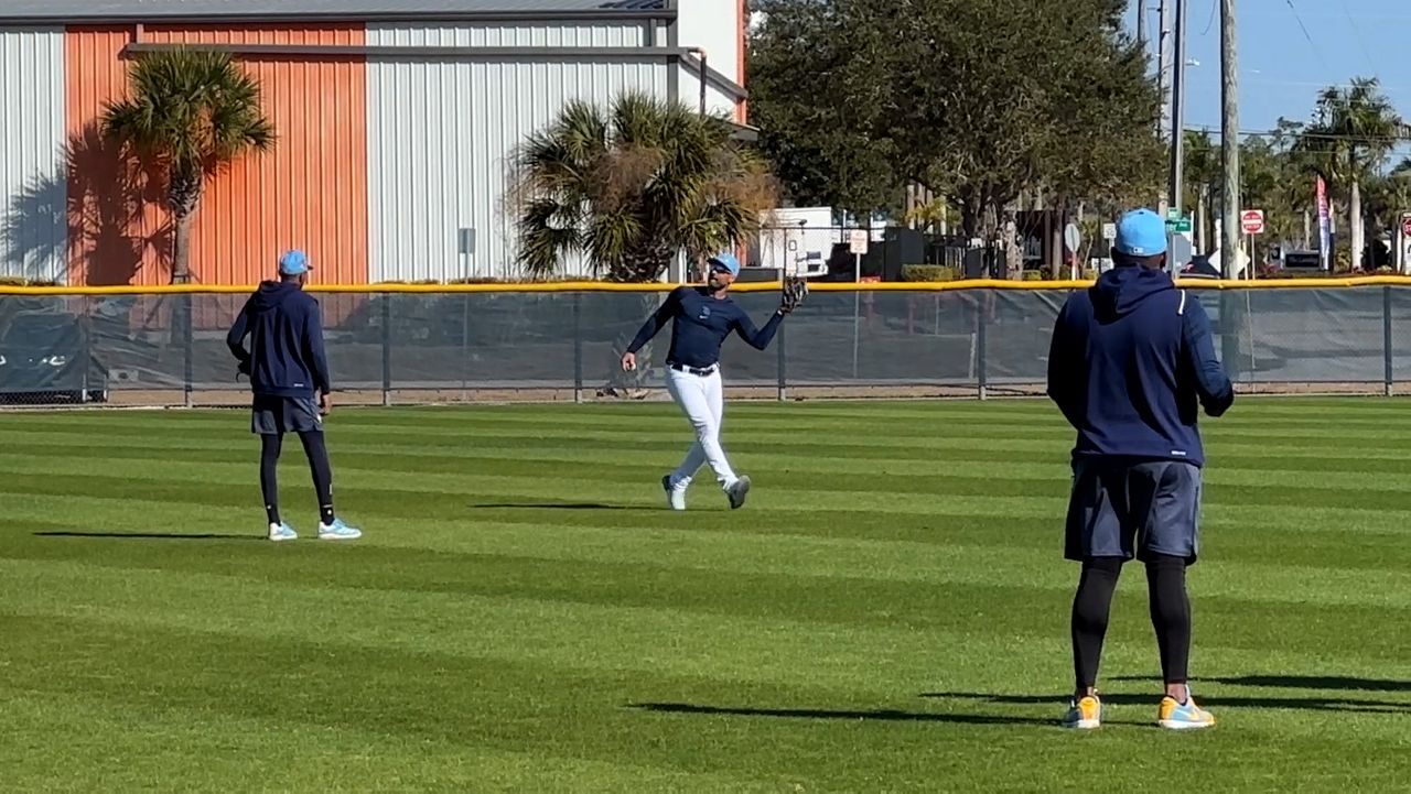 Kevin Kiermaier, center, works with a Rays outfielder in Port Charlotte on Wednesday. (Spectrum Sports 360/Mike Cairns)