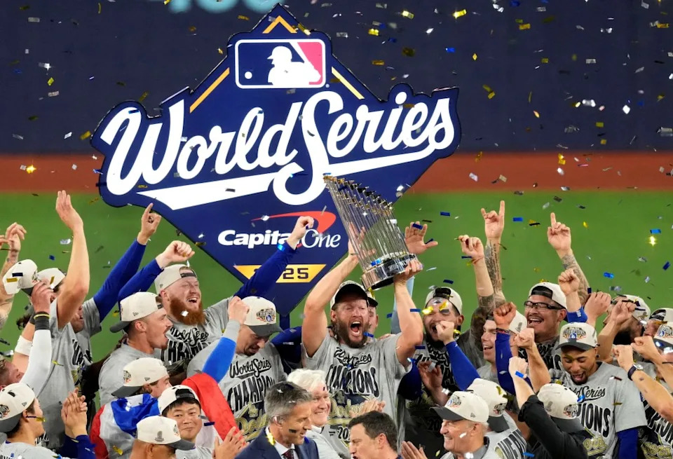 Nov 1, 2025; Toronto, Ontario, CAN; Los Angeles Dodgers pitcher Clayton Kershaw (22) celebrates with the Commissioner’s Trophy after defeating the Toronto Blue Jays in game seven of the 2025 MLB World Series at Rogers Centre. Mandatory Credit: Kevin Sousa-Imagn Images TPX IMAGES OF THE DAY IMAGN IMAGES via Reuters Connect