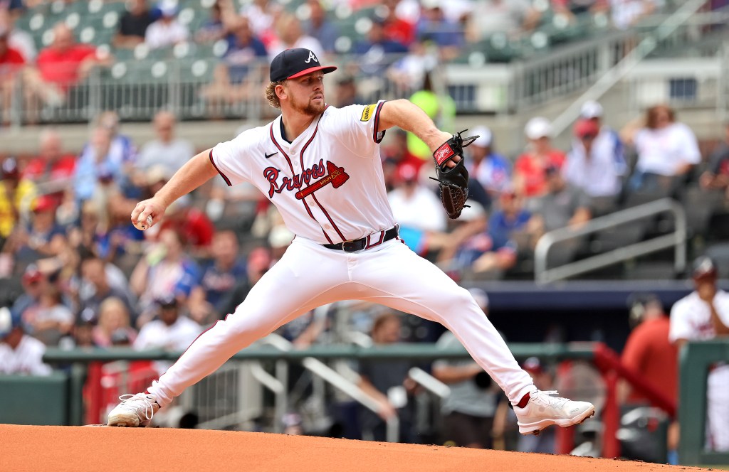 A baseball pitcher throws a pitch.