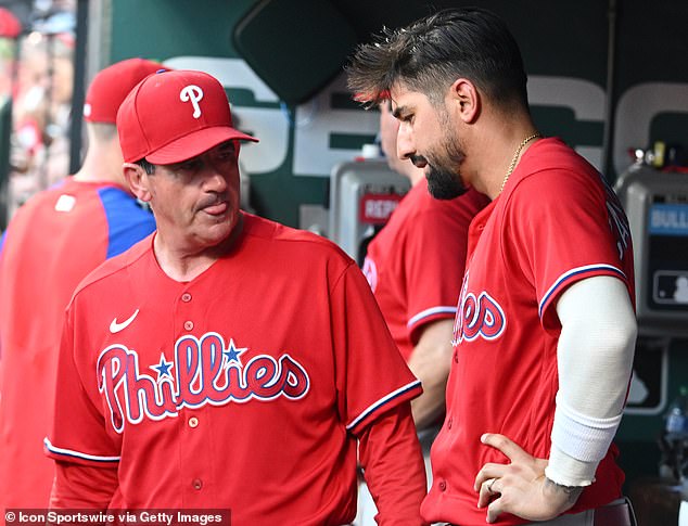 As Castellanos explained in a hand-written letter, which he posted online, he actually tried to bring a beer into the dugout, but was reprimanded by manager Rob Thompson (left)