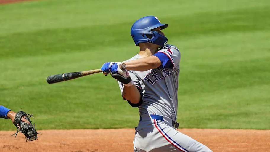 Texas Rangers shortstop Corey Seager swings a bat during a game.  