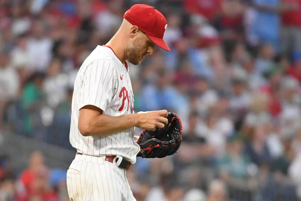 Jul 21, 2025; Philadelphia, Pennsylvania, USA; Philadelphia Phillies pitcher Zack Wheeler (45) checks the baseball after allowing a run during the sixth inning against the Boston Red Sox at Citizens Bank Park. Mandatory Credit: Eric Hartline-Imagn Images